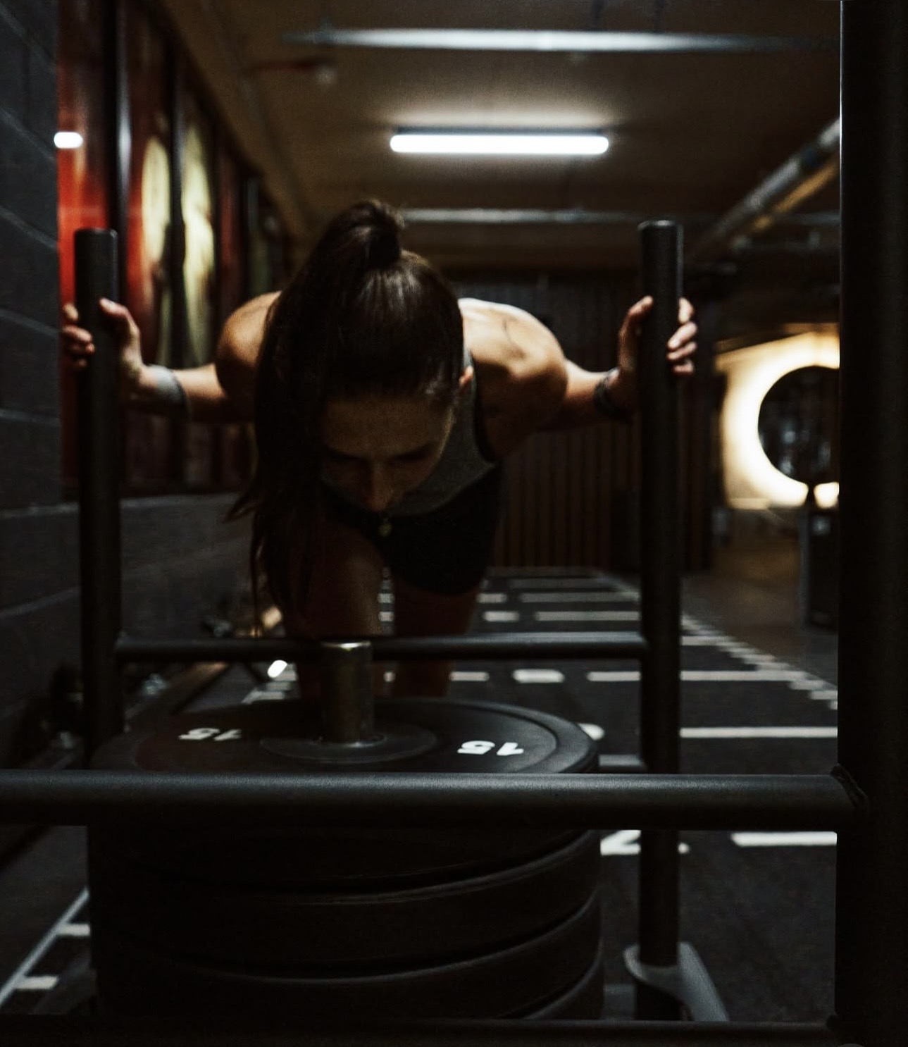 An athlete completing a coached sled session at Training Club Manchester