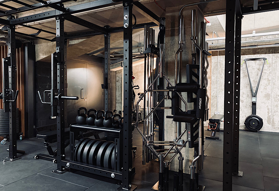 Private strength racks and premium performance equipment inside Training Club