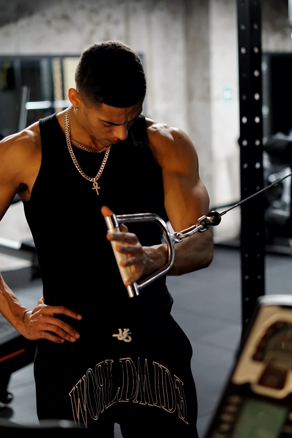 An athlete completing a coached cable exercise